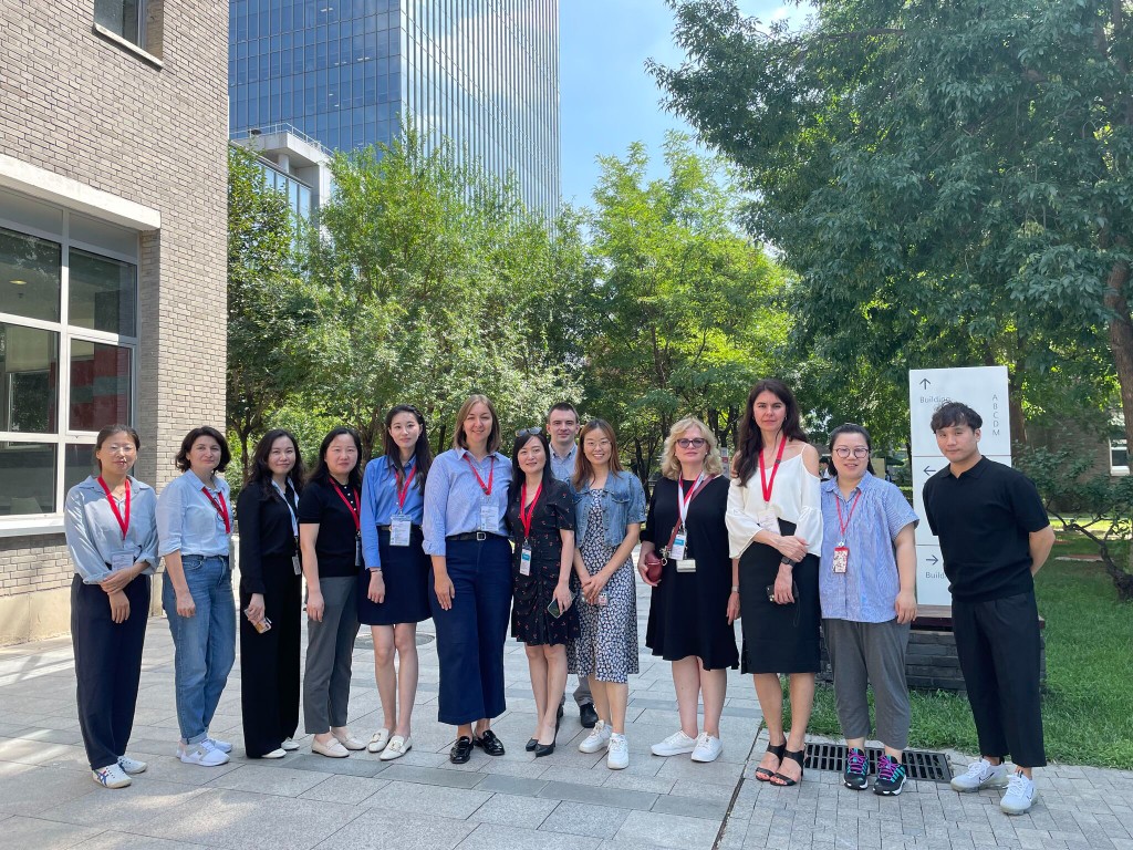 Ludmila Ivashina with her global team outdoors during a professional gathering